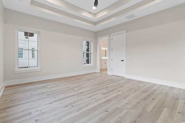 2205 Yellow Morel Way, Myrtle Beach, SC 29579 - spare room featuring a tray ceiling, light wood-type flooring, and baseboards