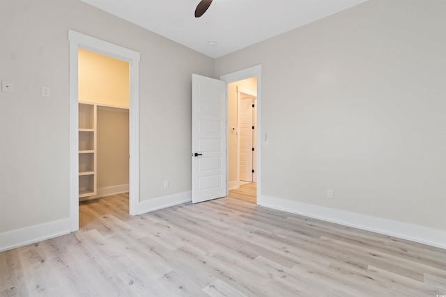 2205 Yellow Morel Way, Myrtle Beach, SC 29579 - unfurnished bedroom with a walk in closet, wood finished floors, baseboards, a ceiling fan, and a closet