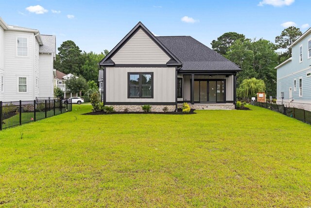 2205 Yellow Morel Way, Myrtle Beach, SC 29579 - rear view of house featuring board and batten siding and a sunroom