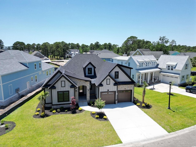 2205 Yellow Morel Way, Myrtle Beach, SC 29579 - view of front facade with board and batten siding, concrete driveway, a garage, a residential view, and stone siding