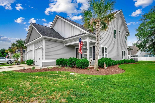 620 Lorenzo Dr Unit 620, North Myrtle Beach, SC 29582 - view of property exterior with board and batten siding, an attached garage, driveway, and roof with shingles