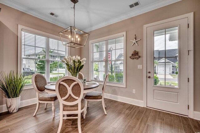 620 Lorenzo Dr Unit 620, North Myrtle Beach, SC 29582 - dining space with a chandelier, baseboards, wood finished floors, and ornamental molding