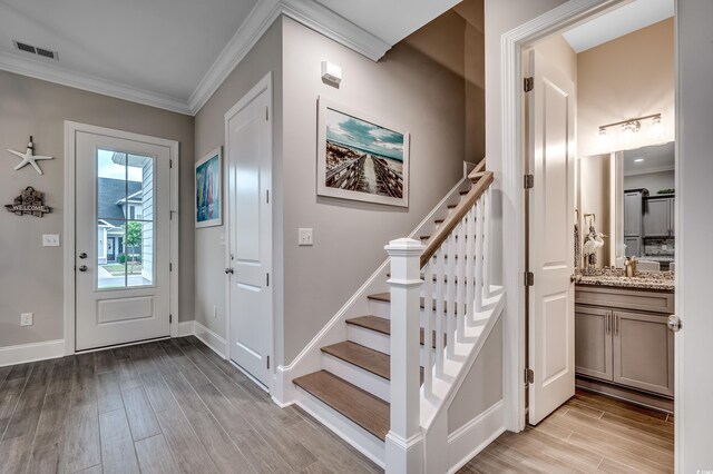 620 Lorenzo Dr Unit 620, North Myrtle Beach, SC 29582 - foyer with light wood-type flooring, crown molding, stairs, and baseboards