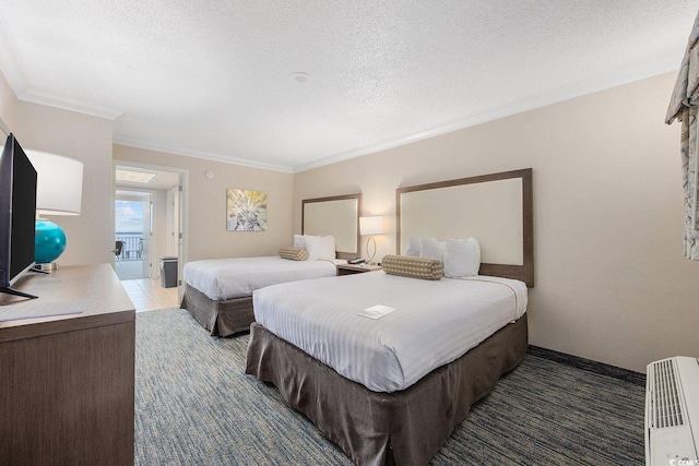 1105 S Ocean Blvd Unit 520, Myrtle Beach, SC 29577 - bedroom featuring crown molding, a textured ceiling, carpet floors, and heating unit