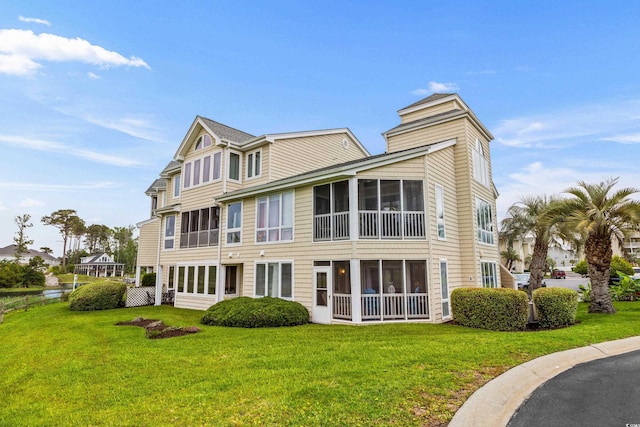 222 Landing Rd Unit 1811, North Myrtle Beach, SC 29582 - back of property with a sunroom and a yard