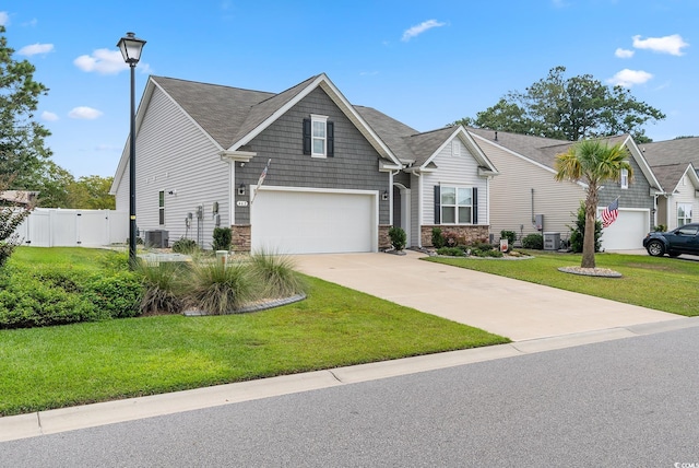 462 Pacific Commons Dr, Surfside Beach, SC 29575 - view of front of home with an attached garage, central AC unit, driveway, stone siding, and a gate