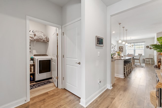 462 Pacific Commons Dr, Surfside Beach, SC 29575 - corridor featuring washer / dryer, a chandelier, light wood-style floors, and baseboards