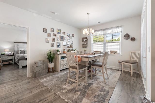 462 Pacific Commons Dr, Surfside Beach, SC 29575 - dining room featuring a chandelier, wood finished floors, and baseboards