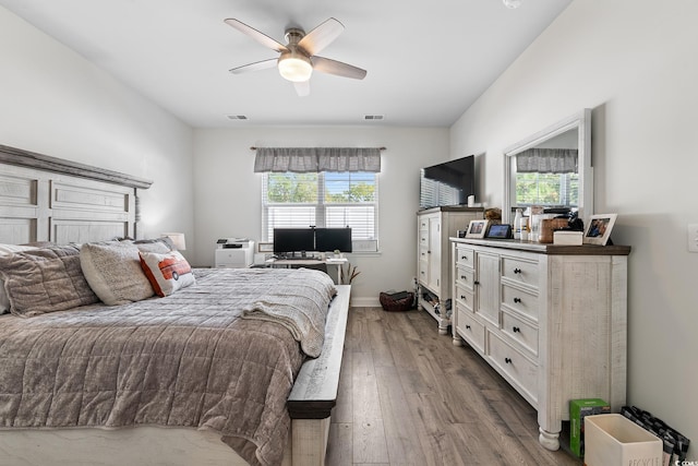 462 Pacific Commons Dr, Surfside Beach, SC 29575 - bedroom with multiple windows, dark wood-style floors, and a ceiling fan