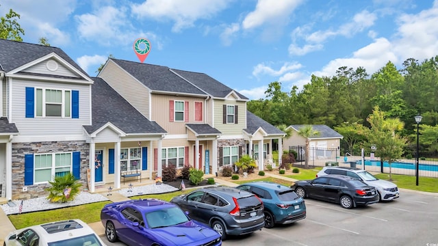 837 Triple Ct Unit 837, Myrtle Beach, SC 29588 - townhome / multi-family property featuring stone siding, uncovered parking, and roof with shingles