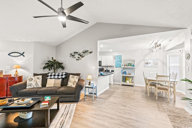 127 Coachman Ln, Surfside Beach, SC 29575 - living room with ceiling fan, lofted ceiling, light wood-style floors, and baseboards