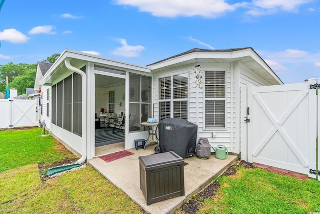 127 Coachman Ln, Surfside Beach, SC 29575 - back of property with a gate, a sunroom, and a patio