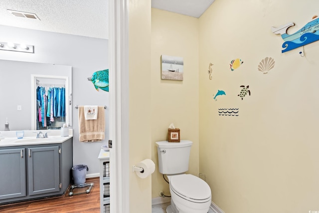 127 Coachman Ln, Surfside Beach, SC 29575 - bathroom with vanity, toilet, wood finished floors, and baseboards