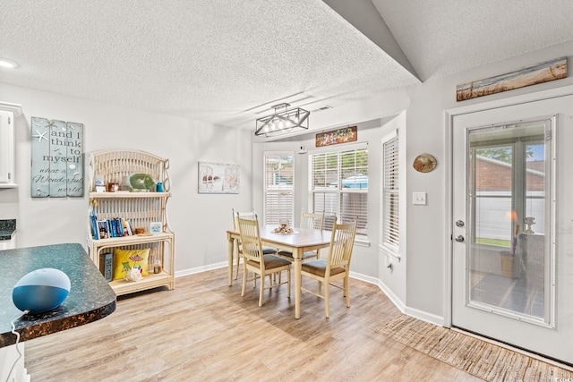 127 Coachman Ln, Surfside Beach, SC 29575 - dining area with a textured ceiling, wood finished floors, plenty of natural light, baseboards, and a chandelier