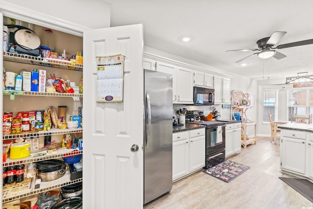127 Coachman Ln, Surfside Beach, SC 29575 - kitchen featuring black appliances, a ceiling fan, white cabinets, light wood-type flooring, and recessed lighting