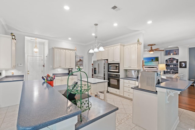 6572 Wellington Dr, Murrells Inlet, SC 29576 - kitchen with appliances with stainless steel finishes, a spacious island, dark countertops, ornamental molding, and ceiling fan