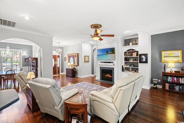 6572 Wellington Dr, Murrells Inlet, SC 29576 - living room featuring a chandelier, arched walkways, ceiling fan, dark wood-style flooring, and crown molding