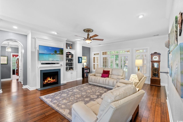 6572 Wellington Dr, Murrells Inlet, SC 29576 - living room featuring dark wood finished floors, ceiling fan, ornamental molding, a warm lit fireplace, and recessed lighting