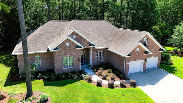 6572 Wellington Dr, Murrells Inlet, SC 29576 - view of front facade featuring driveway, a front yard, and brick siding