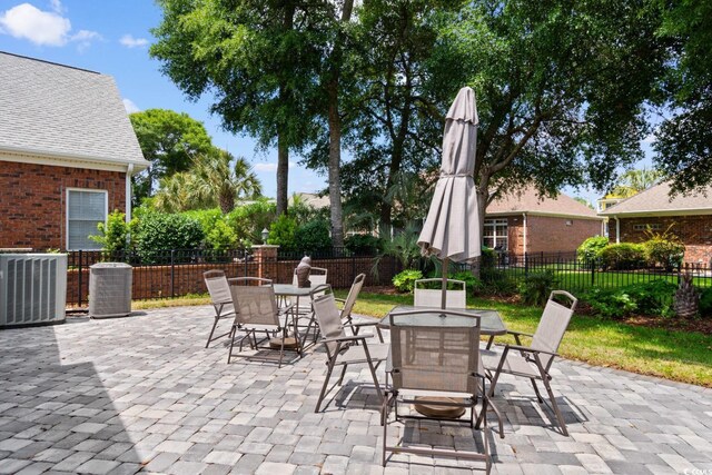 702 Compass Point Dr, North Myrtle Beach, SC 29582 - view of patio / terrace with outdoor dining area and cooling unit