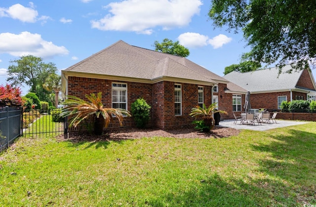 702 Compass Point Dr, North Myrtle Beach, SC 29582 - back of property featuring brick siding, a patio area, and roof with shingles