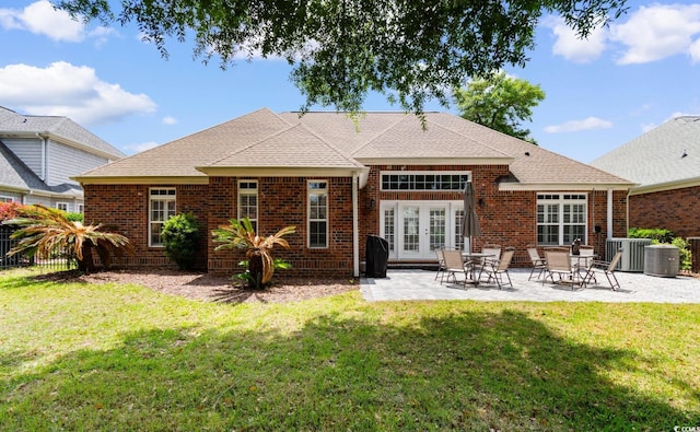 702 Compass Point Dr, North Myrtle Beach, SC 29582 - rear view of house featuring french doors, brick siding, central AC unit, a patio, and a shingled roof