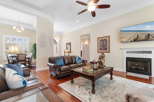 702 Compass Point Dr, North Myrtle Beach, SC 29582 - living area featuring a chandelier, ceiling fan, wood finished floors, a fireplace, and crown molding