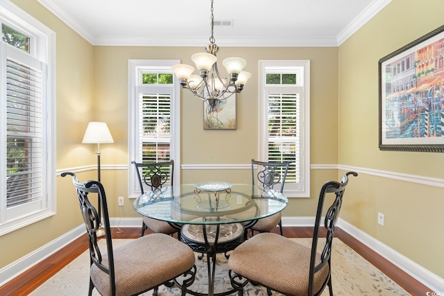 702 Compass Point Dr, North Myrtle Beach, SC 29582 - dining room featuring dark wood finished floors, plenty of natural light, a chandelier, crown molding, and baseboards