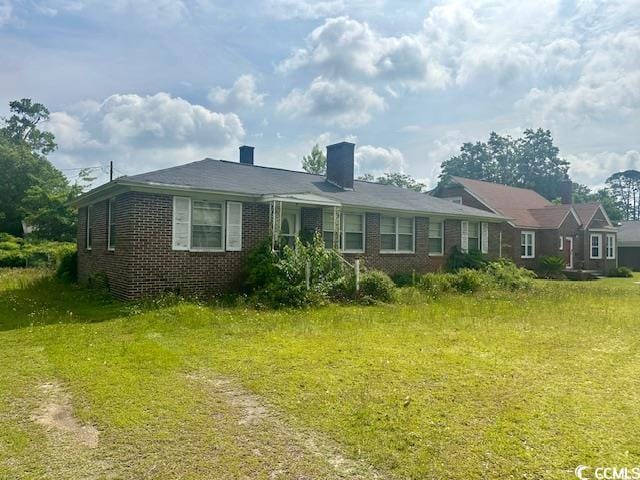 905 E Main St, Dillon, SC 29536 - view of front facade with brick siding and a chimney