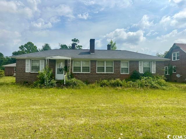 905 E Main St, Dillon, SC 29536 - view of front of home with brick siding and a chimney