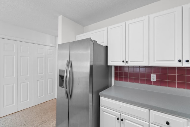4505 Lightkeepers Way Unit 24B, Little River, SC 29566 - kitchen featuring stainless steel fridge with ice dispenser, white cabinets, a textured ceiling, decorative backsplash, and carpet flooring