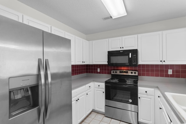 4505 Lightkeepers Way Unit 24B, Little River, SC 29566 - kitchen featuring stainless steel appliances, white cabinetry, light countertops, decorative backsplash, and a textured ceiling