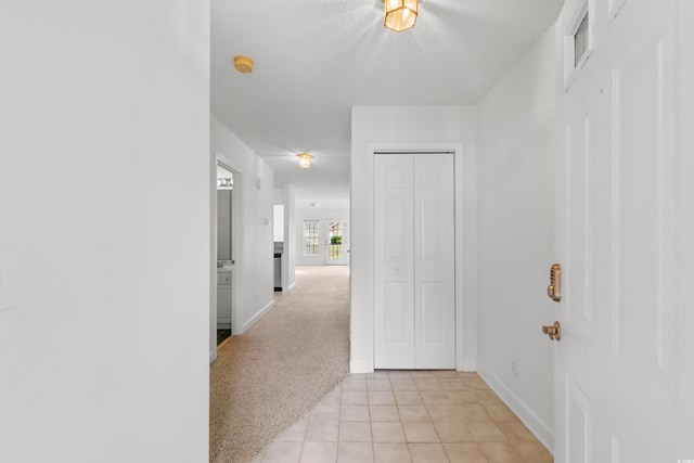 4505 Lightkeepers Way Unit 24B, Little River, SC 29566 - hallway with baseboards, light tile patterned flooring, light carpet, and a textured ceiling