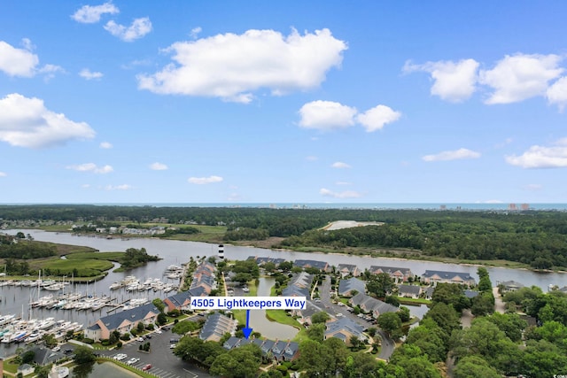 4505 Lightkeepers Way Unit 24B, Little River, SC 29566 - bird's eye view of a large body of water, a marina, and a tree filled landscape