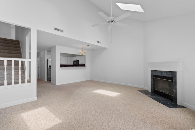 4505 Lightkeepers Way Unit 24B, Little River, SC 29566 - unfurnished living room featuring carpet floors, high vaulted ceiling, a chandelier, a high end fireplace, and a skylight