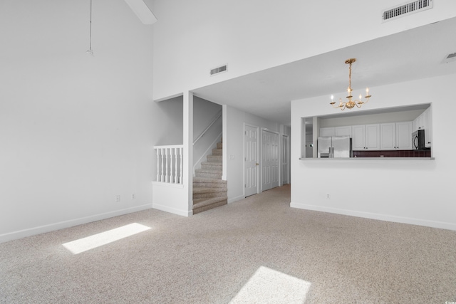 4505 Lightkeepers Way Unit 24B, Little River, SC 29566 - unfurnished living room with stairs, a chandelier, light carpet, and baseboards