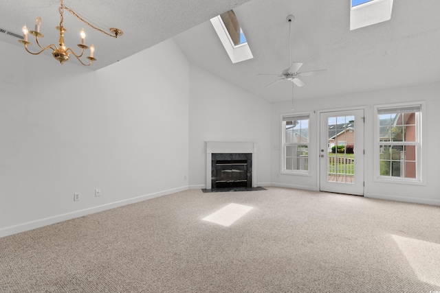 4505 Lightkeepers Way Unit 24B, Little River, SC 29566 - unfurnished living room featuring a skylight, carpet flooring, a high end fireplace, baseboards, and high vaulted ceiling