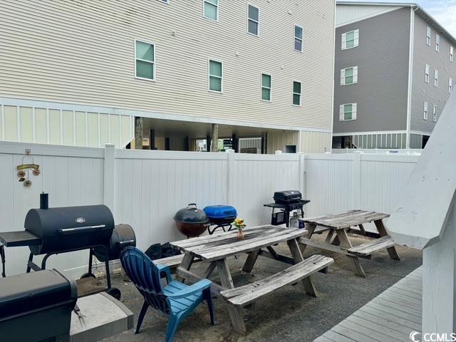 5409 N Ocean Blvd Unit 111, North Myrtle Beach, SC 29582 - fenced backyard with outdoor dining area and grilling area
