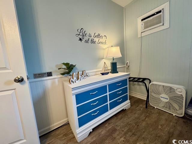 5409 N Ocean Blvd Unit 111, North Myrtle Beach, SC 29582 - interior space with dark wood-type flooring, a decorative wall, and a wall unit AC