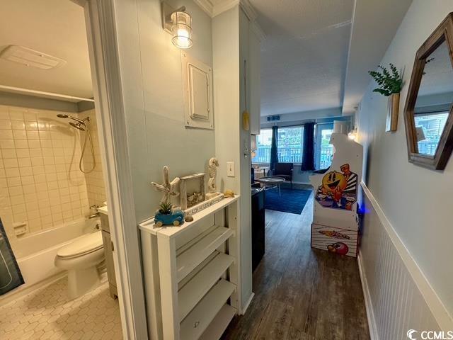 5409 N Ocean Blvd Unit 111, North Myrtle Beach, SC 29582 - corridor featuring crown molding and dark wood finished floors