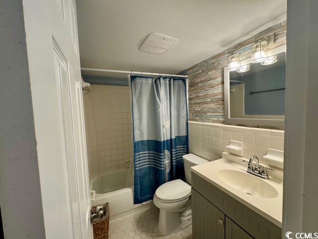 5409 N Ocean Blvd Unit 111, North Myrtle Beach, SC 29582 - bathroom with vanity, tile walls, toilet, and shower / bath combo