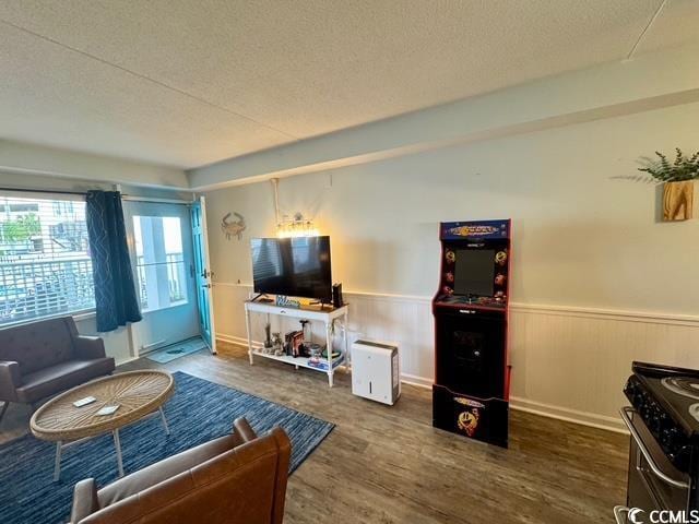 5409 N Ocean Blvd Unit 111, North Myrtle Beach, SC 29582 - living area with a wainscoted wall, wood finished floors, and a textured ceiling