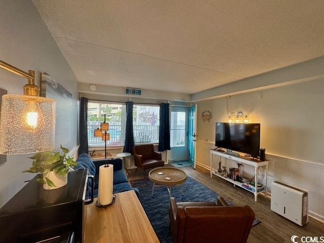 5409 N Ocean Blvd Unit 111, North Myrtle Beach, SC 29582 - living area with wood finished floors, plenty of natural light, and wainscoting