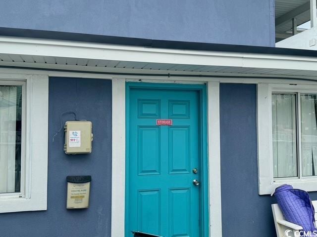 5409 N Ocean Blvd Unit 111, North Myrtle Beach, SC 29582 - view of exterior entry featuring stucco siding