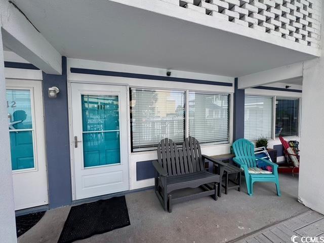 5409 N Ocean Blvd Unit 111, North Myrtle Beach, SC 29582 - view of exterior entry featuring stucco siding