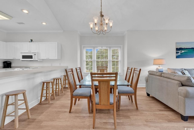 4811 Orchid Way Unit 301, Myrtle Beach, SC 29577 - dining space with light wood-type flooring, crown molding, a chandelier, and recessed lighting