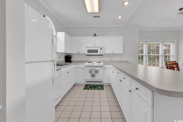 4811 Orchid Way Unit 301, Myrtle Beach, SC 29577 - kitchen with white appliances, a peninsula, light countertops, white cabinetry, and ornamental molding
