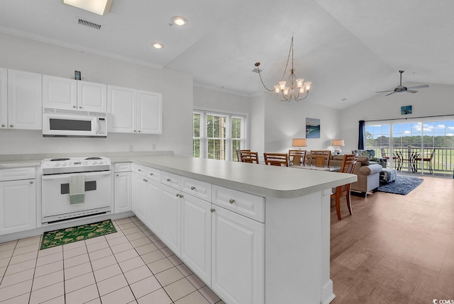 4811 Orchid Way Unit 301, Myrtle Beach, SC 29577 - kitchen featuring white appliances, a peninsula, light countertops, vaulted ceiling, and ceiling fan