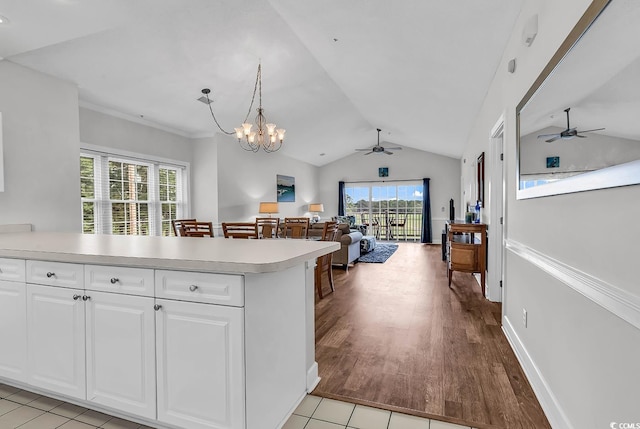 4811 Orchid Way Unit 301, Myrtle Beach, SC 29577 - kitchen with ceiling fan, light countertops, vaulted ceiling, a peninsula, and open floor plan