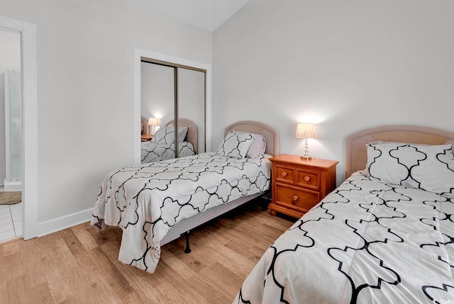 4811 Orchid Way Unit 301, Myrtle Beach, SC 29577 - bedroom featuring a closet, light wood-style flooring, lofted ceiling, and connected bathroom